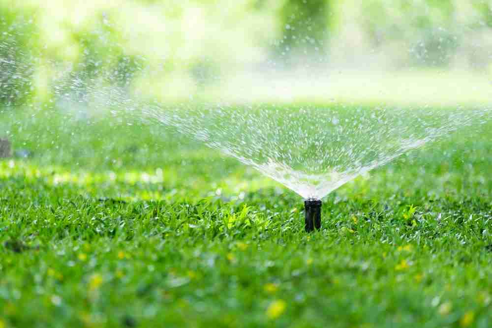 Automatic Garden Lawn Sprinkler In Action Watering Grass. Sprinkler Repair Dallas, TX | Sprinkler System Deals