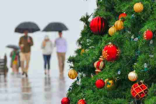 Christmas lights stop working when it rains, showing wet floors outdoors with glowing holiday lights, highlighting how to protect Christmas lights from rain and wet weather