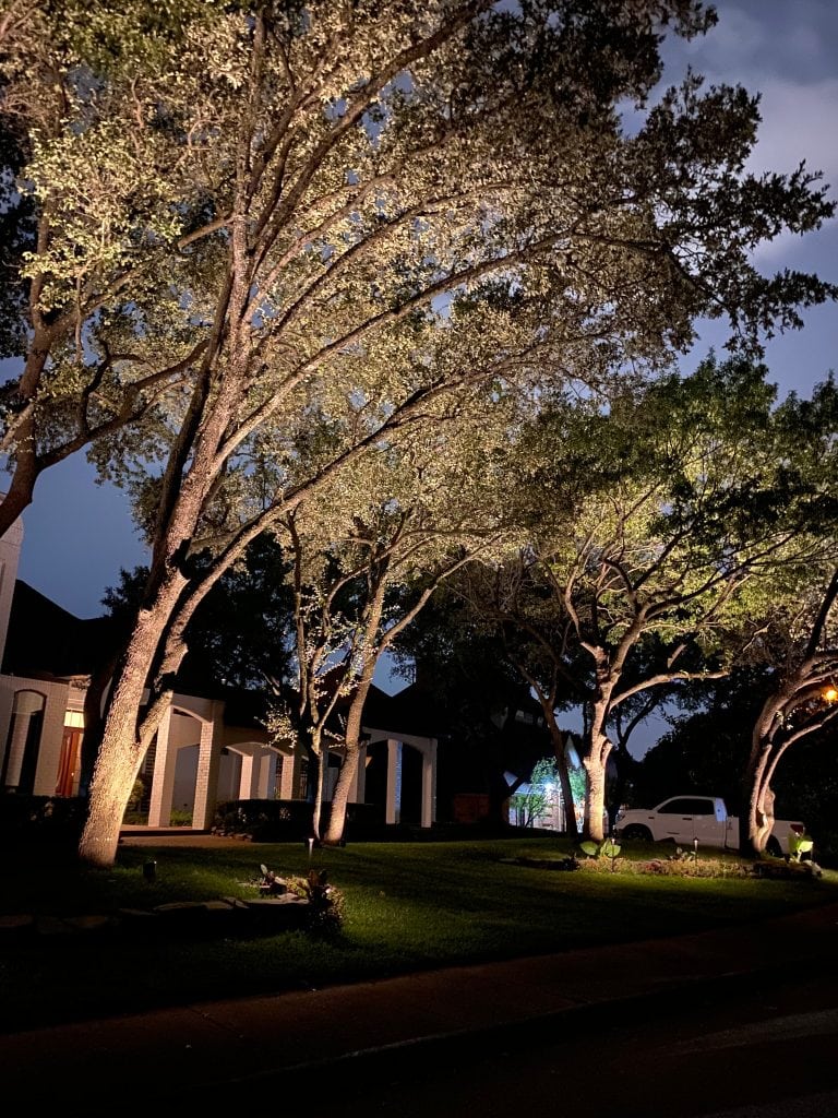 Property with a slew of lighting across the front porch. Tree Uplighting Dallas, TX