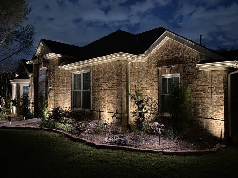 Home with a flower bed and curb appeal for front porch. Landscape Lighting Services Dallas, TX